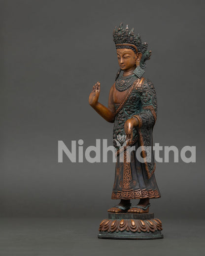 left view of standing dipankara buddha statue with intricate robe and lotus details