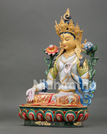 left view of white tara statue with traditional nepalese buddhist artistry