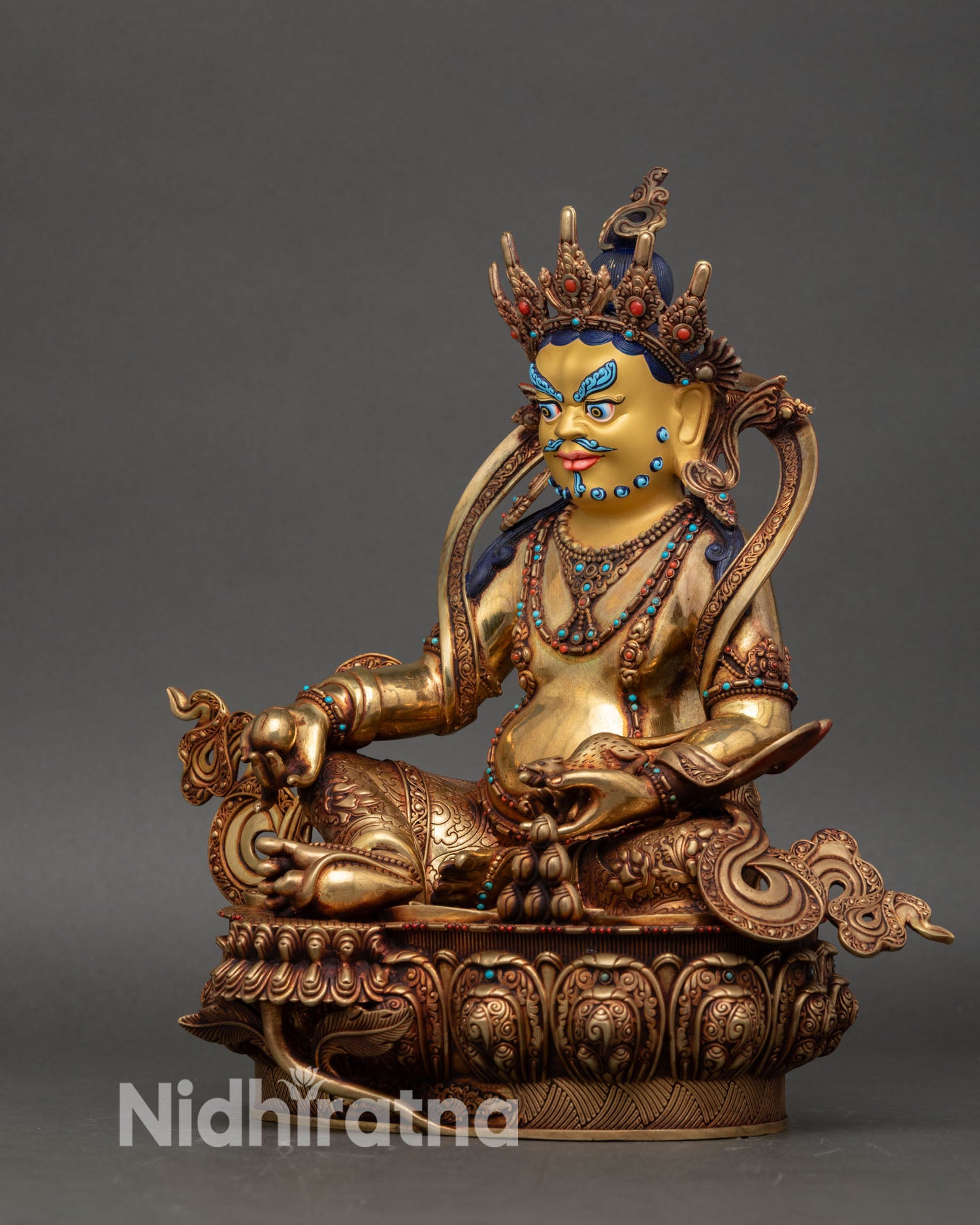 left view side dzambhala statue showing carved details and gold-painted accents