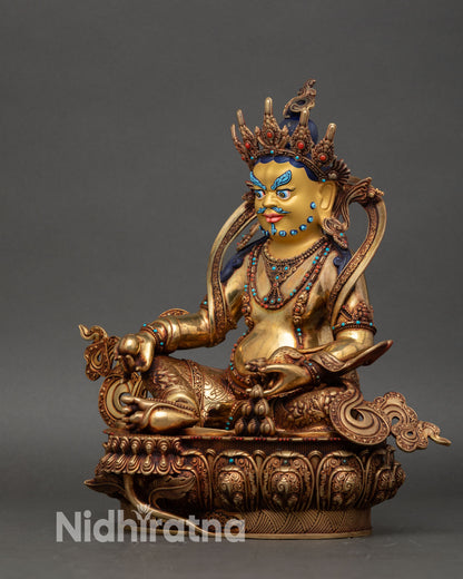 left view side dzambhala statue showing carved details and gold-painted accents