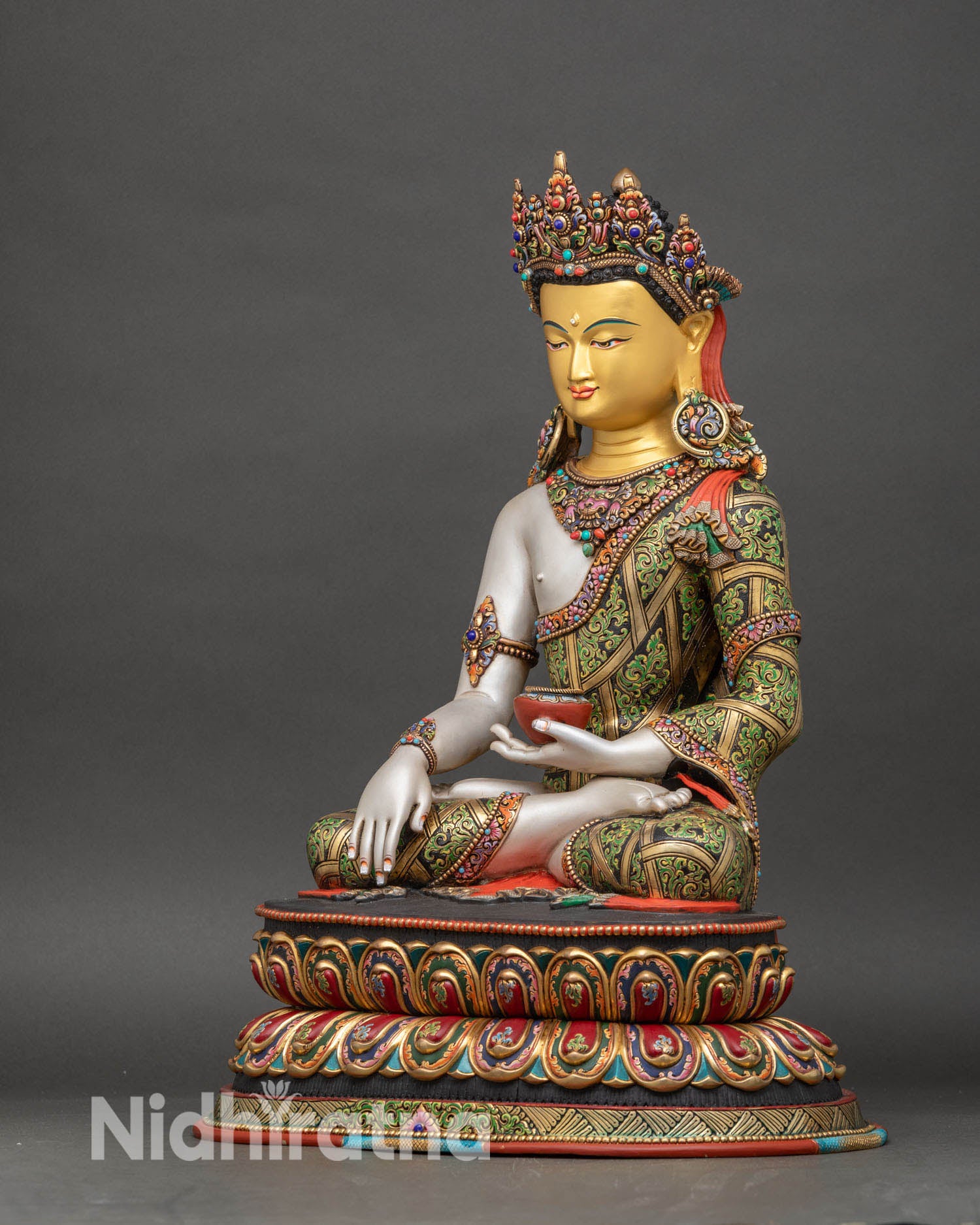 left view side of crown shakyamuni buddha statue showing begging bowl and ornate crown details