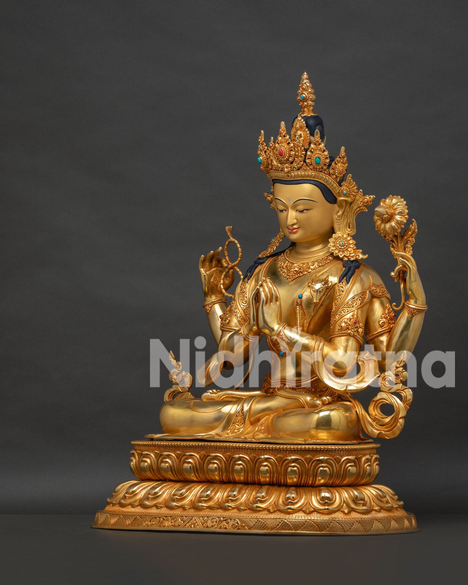 Left view side of four armed Avalokiteshvara statue with lotus throne and gold fire gilded details