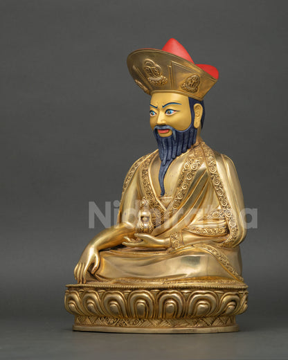Left side view of Zhabdrung Rinpoche statue with intricate repoussé robes