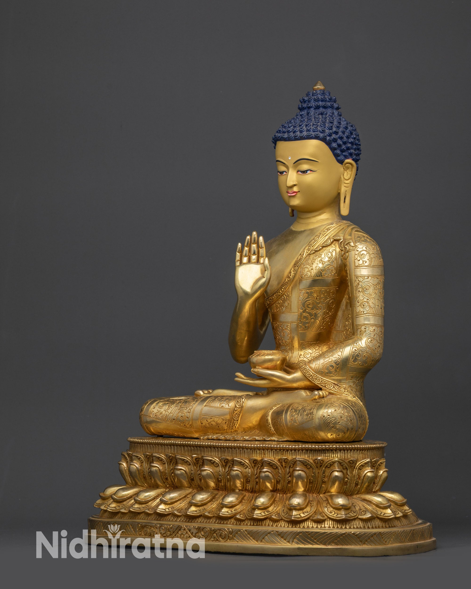 left view side amoghasiddhi buddha statue monk robe floral designs and polished finish
