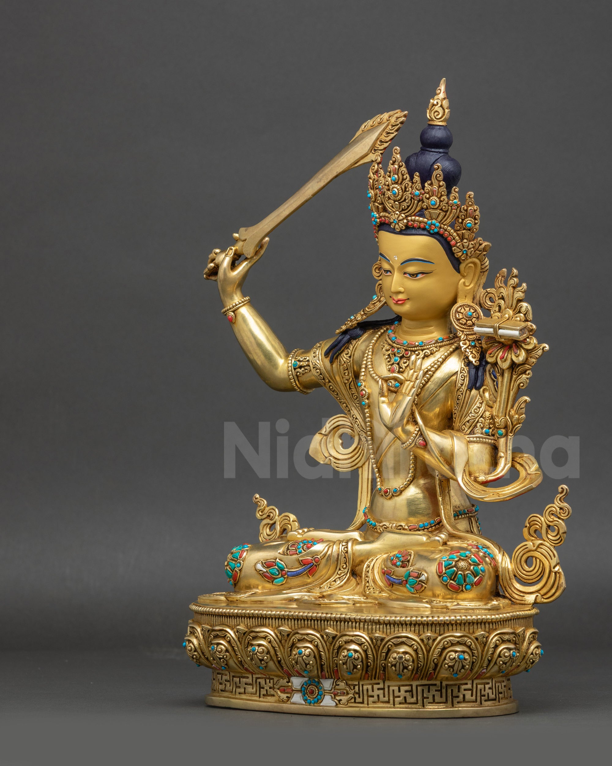 left view side of Manjushri Buddha statue with intricate gold-gilded details
