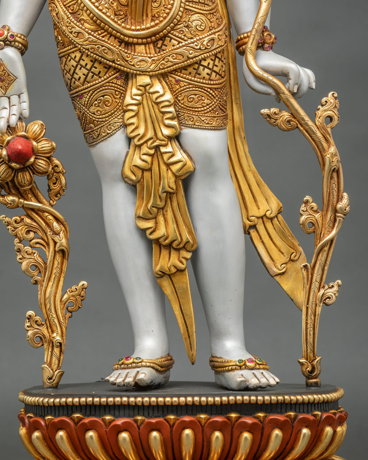 Lokeshvara statue lower body with engraved gold gilded garment, flowing sashes and jeweled anklets