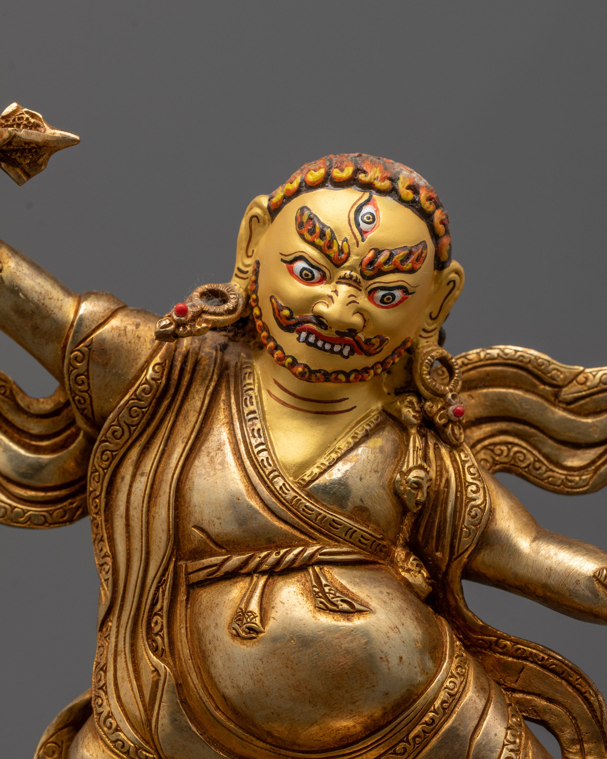 lose-up of Dorje Drolo Statue Showing Detailed Face and Gold Fire Gilded