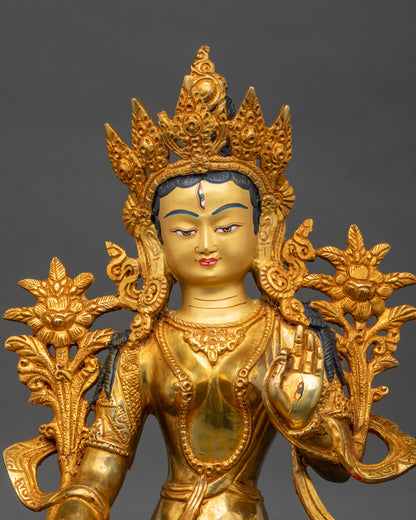 Close-up of White Tara Bodhisattva face with gold paint and seven-eyed detail