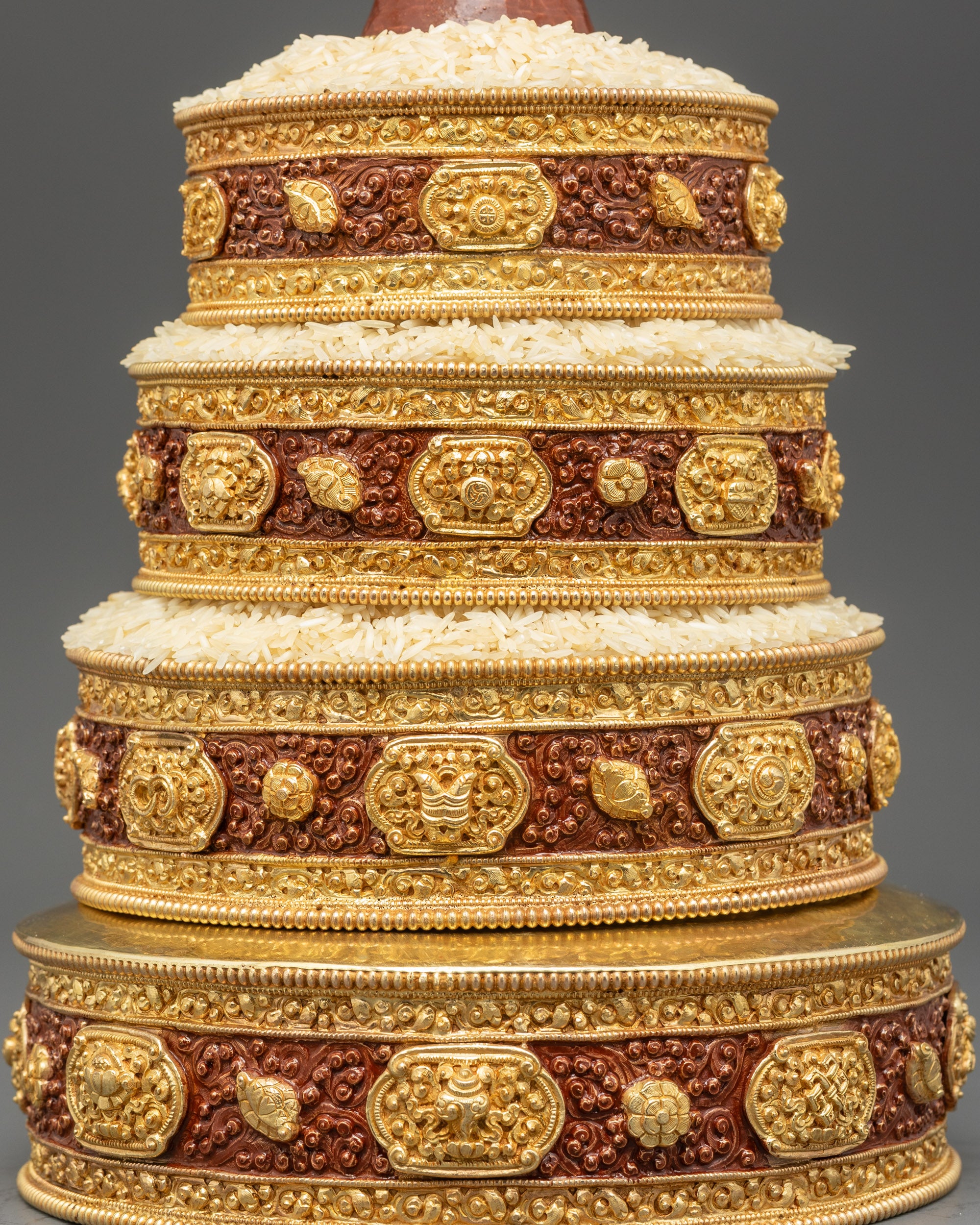 lose up mandala detail showing gold-plated auspicious motifs and richly layered colors