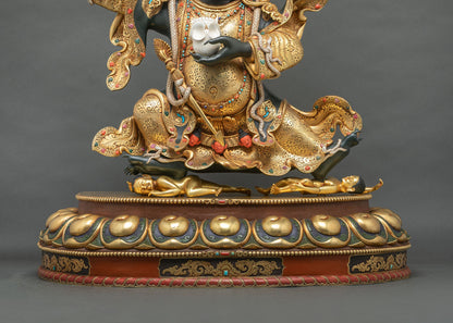 Lotus pedestal of Mahakala Bernagchen statue with two subdued golden figures and hand-chased gold robes