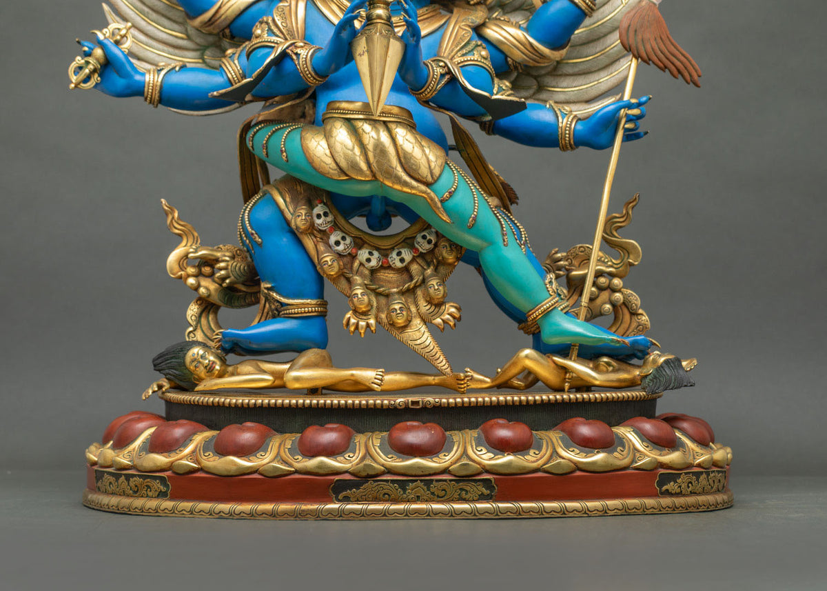 Lotus pedestal of Vajrakilaya statue with two golden subdued figures and severed head garland