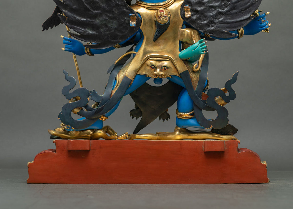 Lower back of Vajrakilaya statue with gilded cloak face detail, flowing sashes and red base