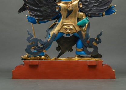Lower back of Vajrakilaya statue with gilded cloak face detail, flowing sashes and red base