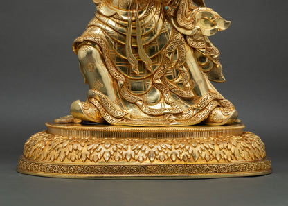Lower front detail of Guru Rinpoche statue with lotus pedestal and flowing ceremonial robes