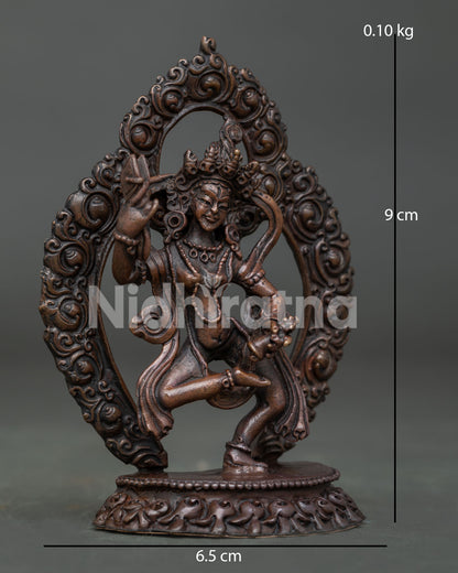 Machig Labdron statue dancing on moon disc above lotus seat with ritual damaru.