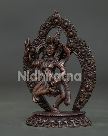 Machig Labdron statue side view holding ritual bell and damaru in dancing posture.