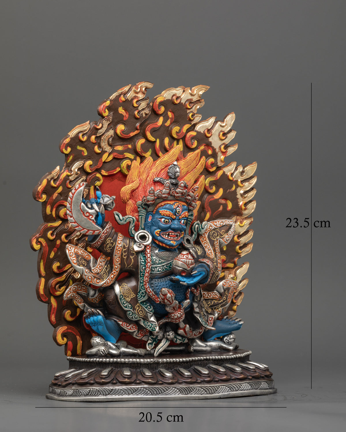 Mahakala bernagchen standing on two human figures with flaming halo.