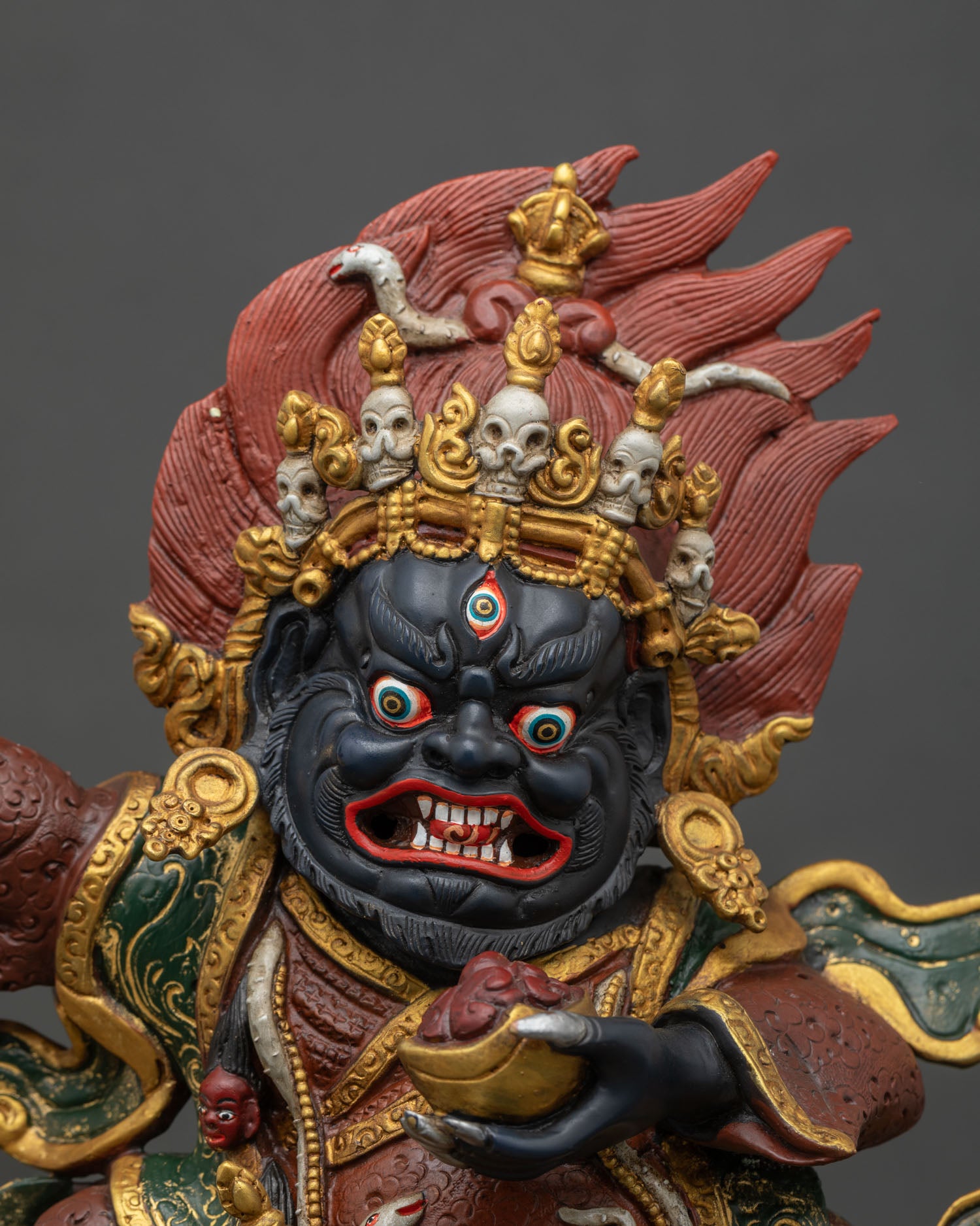 Close-up of Mahakala Bernagchen statue showing gold gilding and hand-painted details