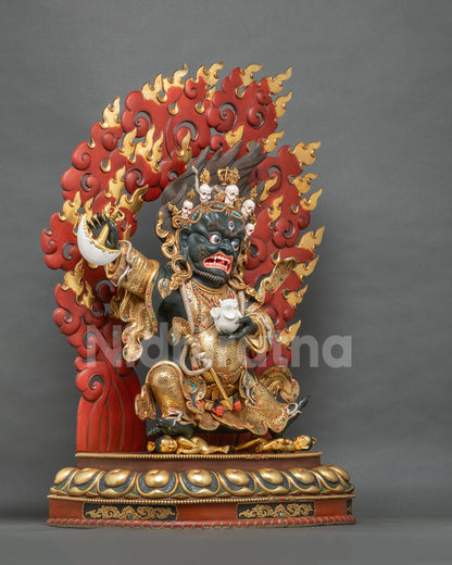 Mahakala Bernagchen statue three-quarter view with crimson flame halo and gilded lotus pedestal