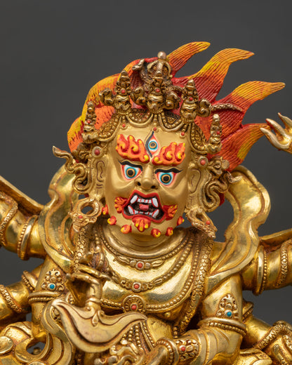Mahakala statue close up fierce third eye face gold painted, Buddhist tantric protector deity art