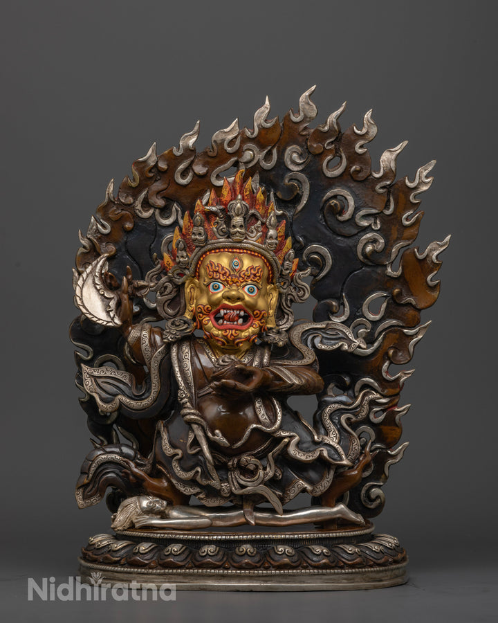 mahakala bernagchen statue with pure gold plated face and silver accents on a oxidized brown copper base