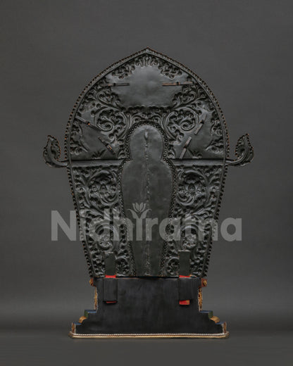 Maitreya Buddha statue back view showing copper sculpture and ornate halo