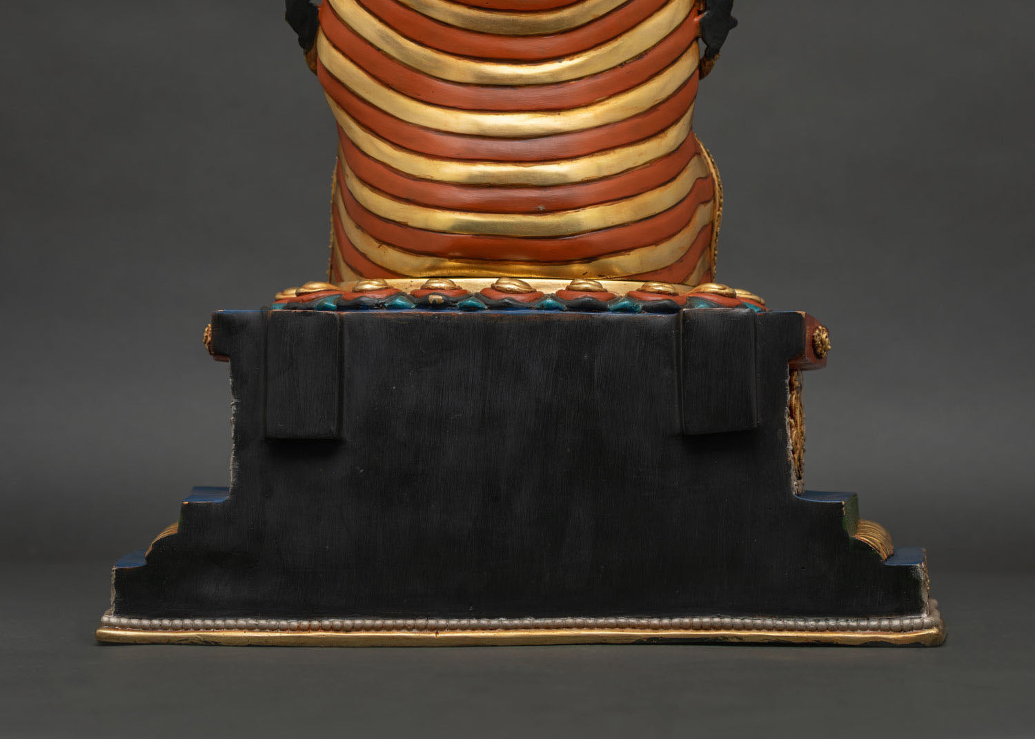 Maitreya Buddha statue base close-up showing ornate pedestal and finishing details