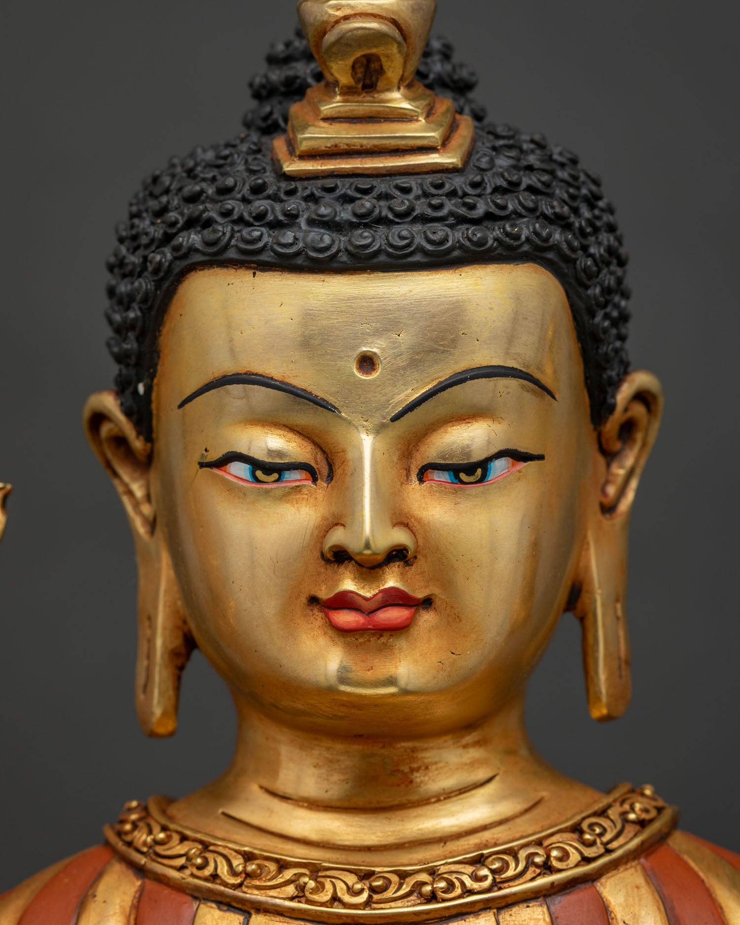 Maitreya Buddha statue detailed face close-up with gold fire-gilded finish