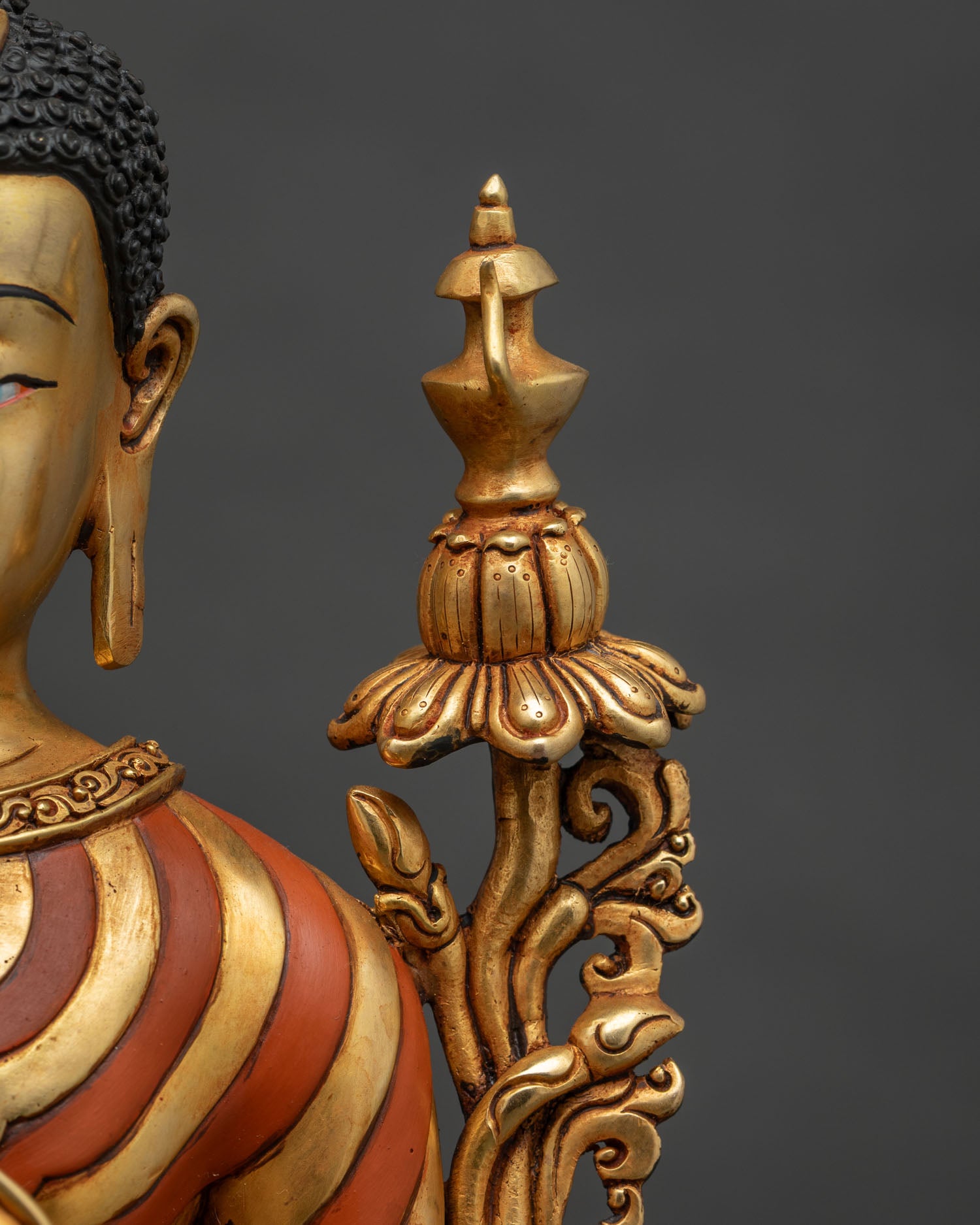 Maitreya Buddha statue lower throne detail with Dharma wheel ornament