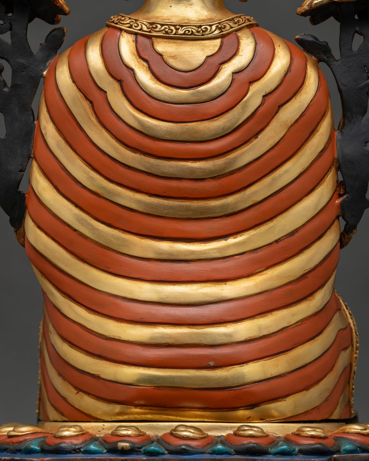 Maitreya Buddha statue robe close-up showing diagonal striped monastic robe
