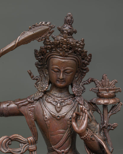 Manjushri bodhisattva face showing serene expression and intricate buddhist craftsmanship.