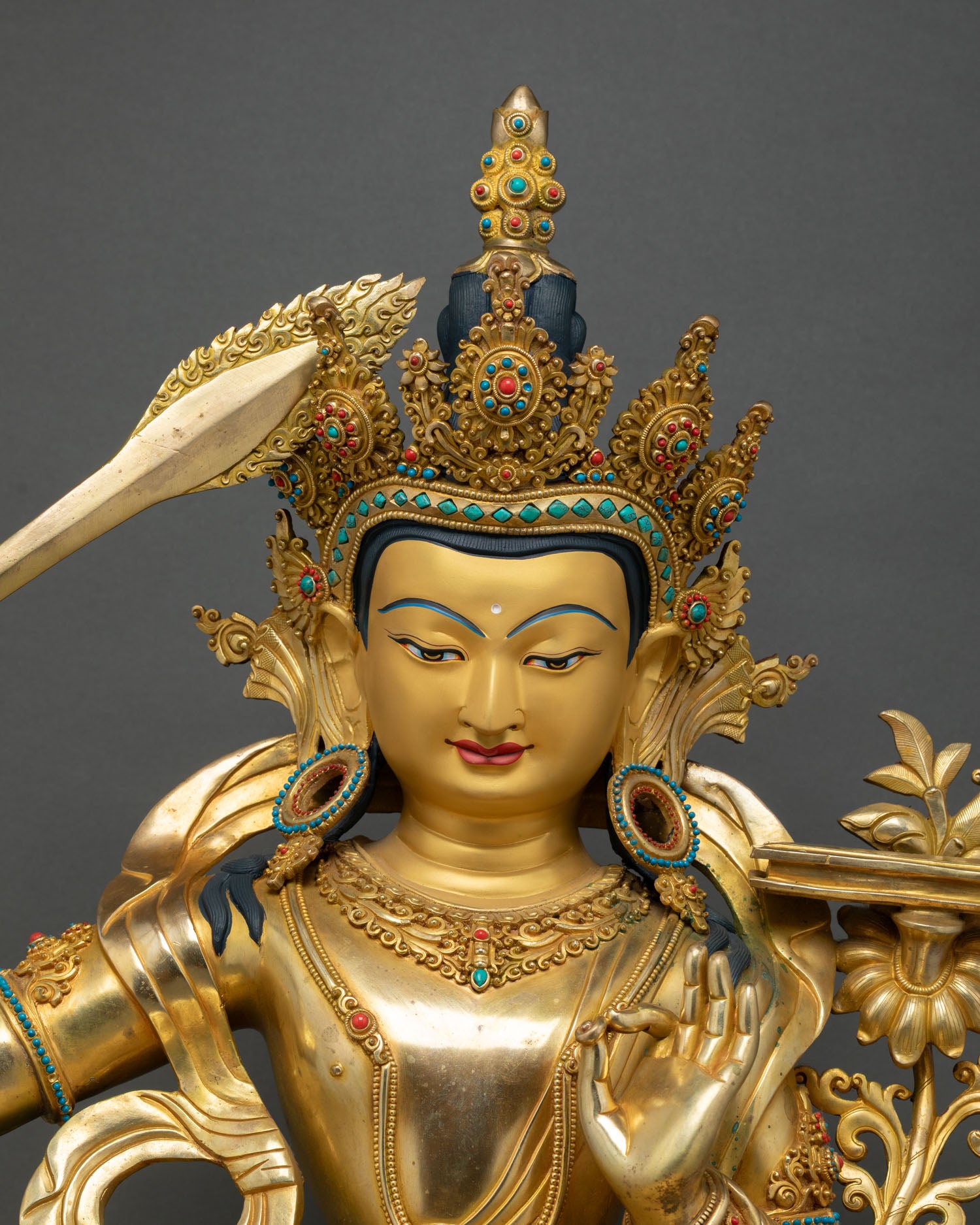 Manjushri Bodhisattva statue close-up, jeweled crown and serene gold face