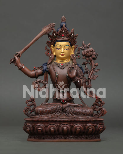 Manjushri Bodhisattva statue handcrafted copper with oxidized finish and gold painted face from Nepal.