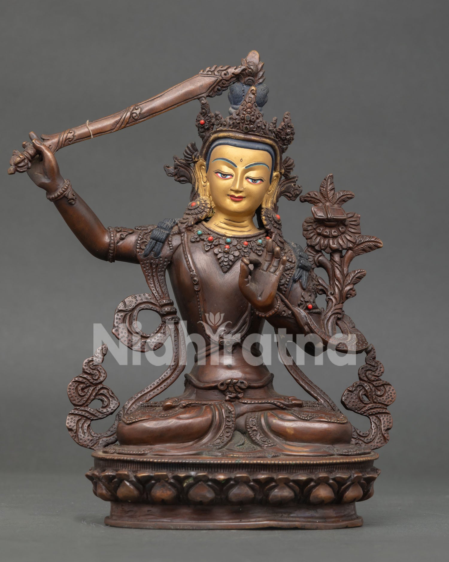 Manjushri Bodhisattva statue handcrafted in copper with oxidized finish and gold painted face from Nepal.