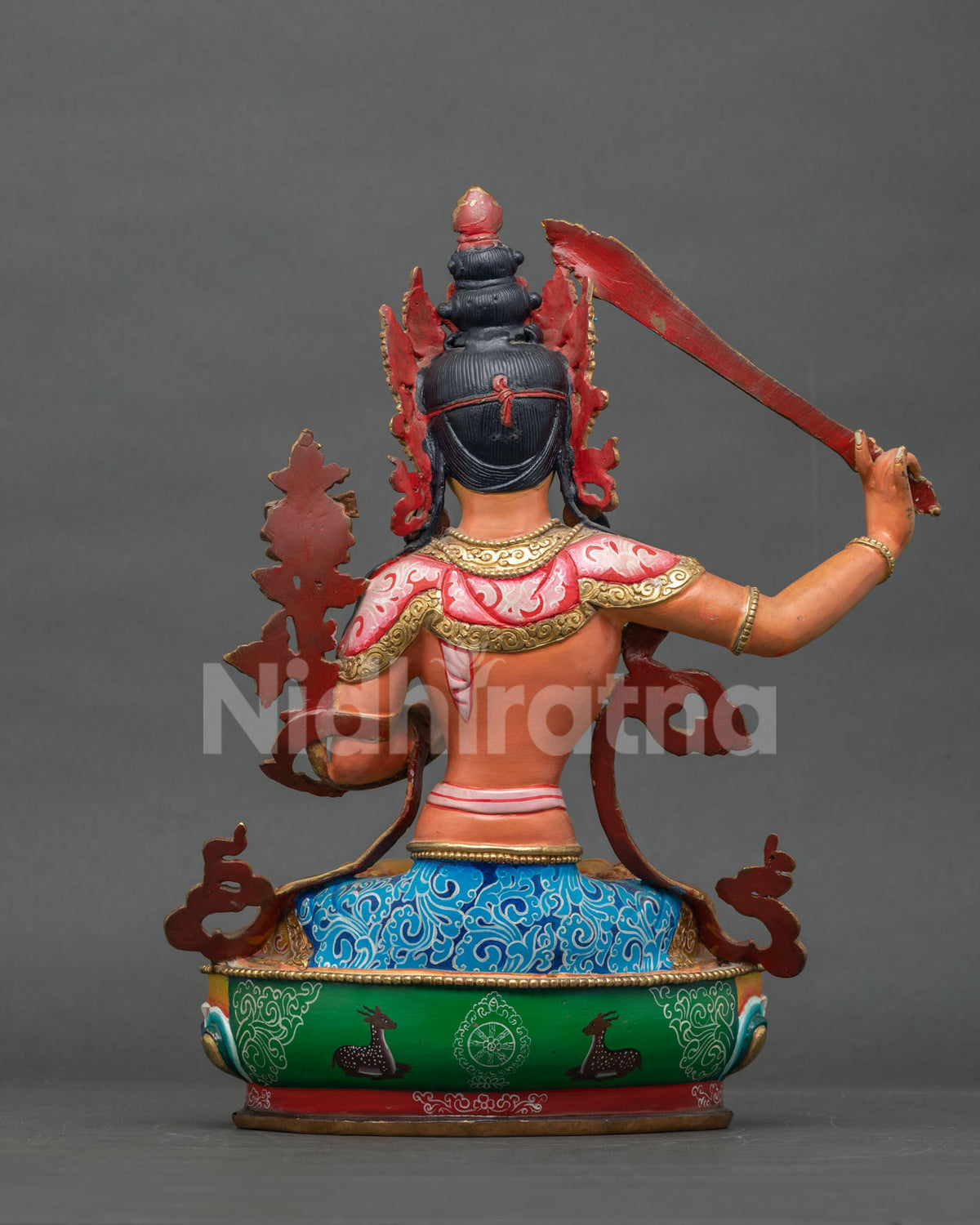 Manjushri Buddhist statue with utpala lotus sacred scripture and intricate gold details.