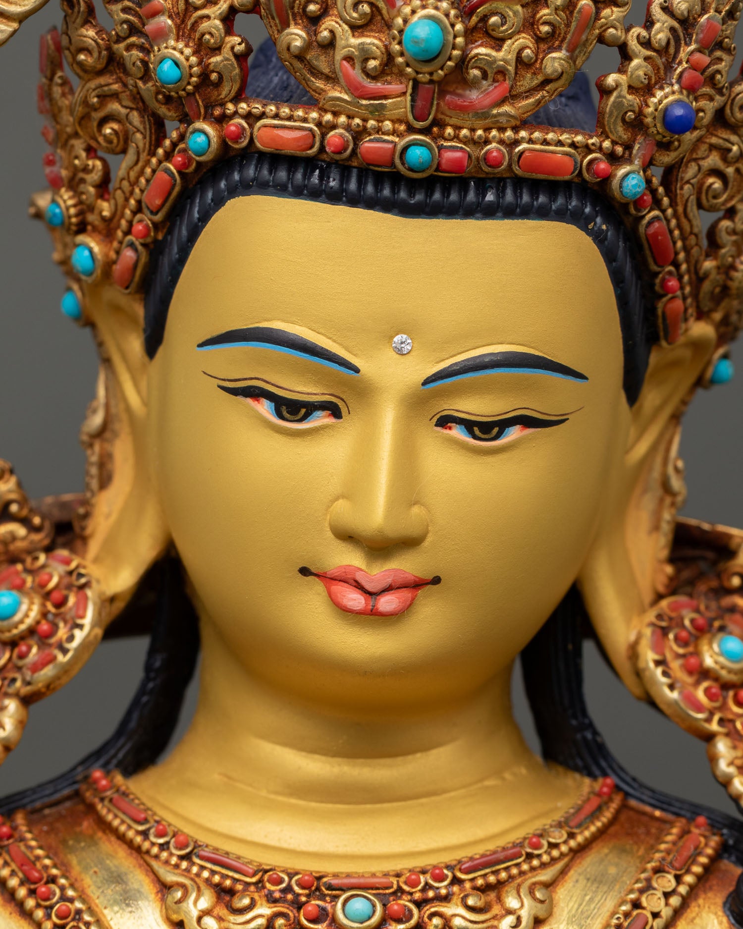 manjushri face close up, serene expression gold gilded wisdom deity