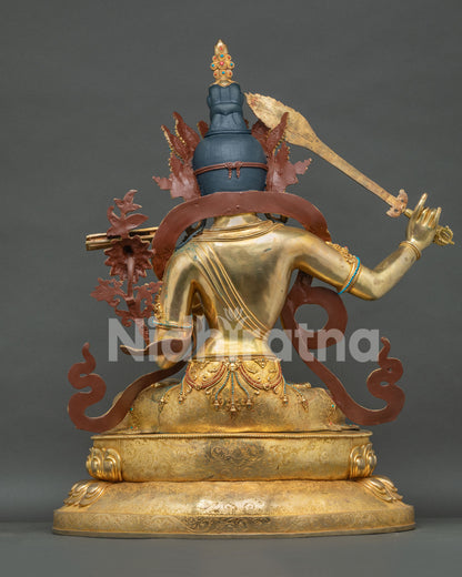 Manjushri statue back view, hand-chased detailing and flowing scarves