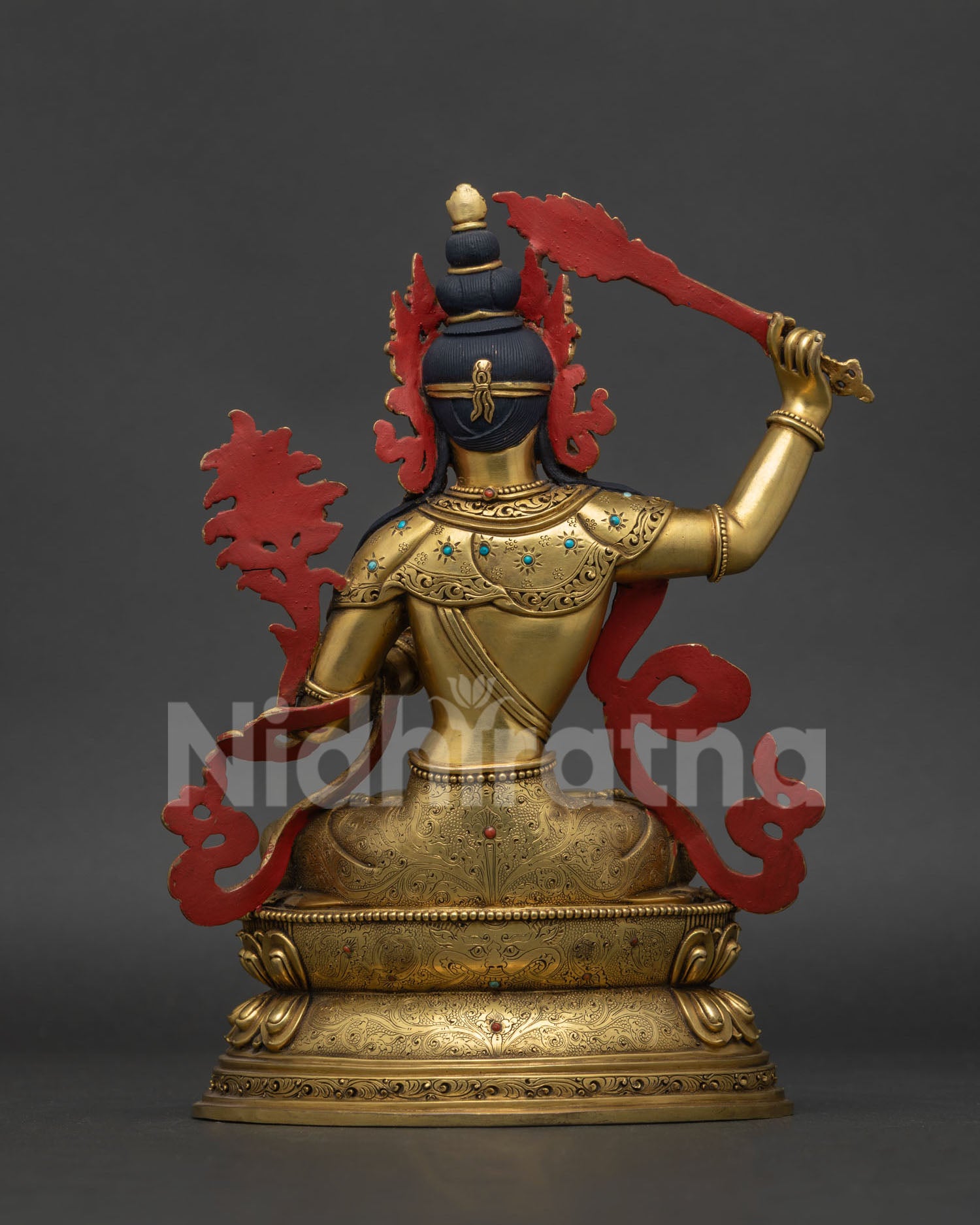 Manjushri statue back view showing detailed copper casting and traditional Newari artwork