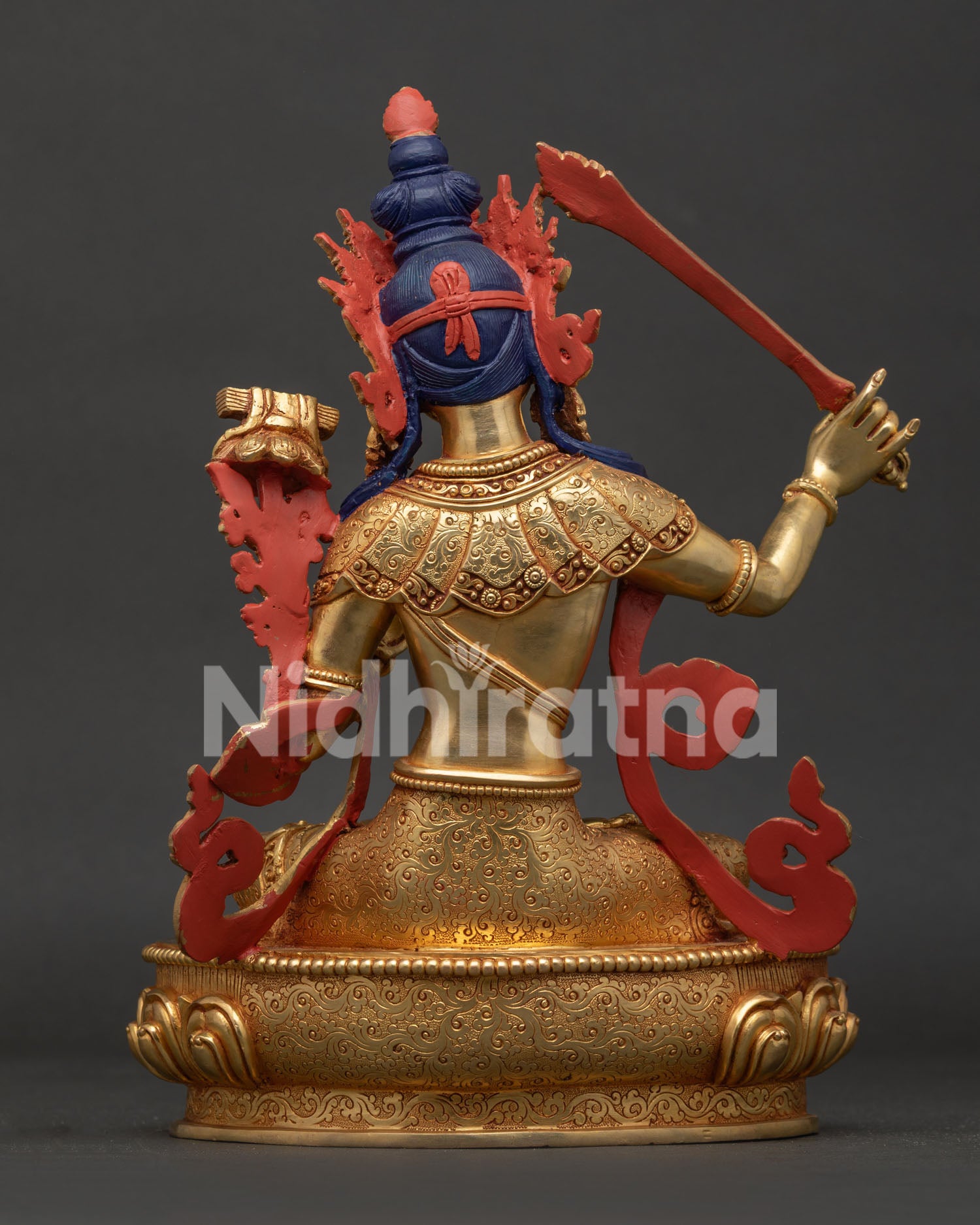 Manjushri statue back view showing hand carved robe and traditional Newari artistry.
