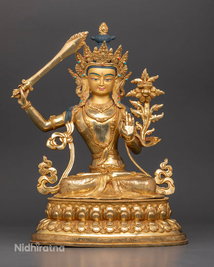 Manjushri statue Bodhisattva of Wisdom gold fire gilded Nepalese Buddhist statue front view.