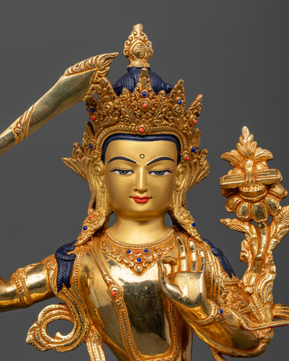Manjushri Statue close up 24K gold painted face gold gilded details.