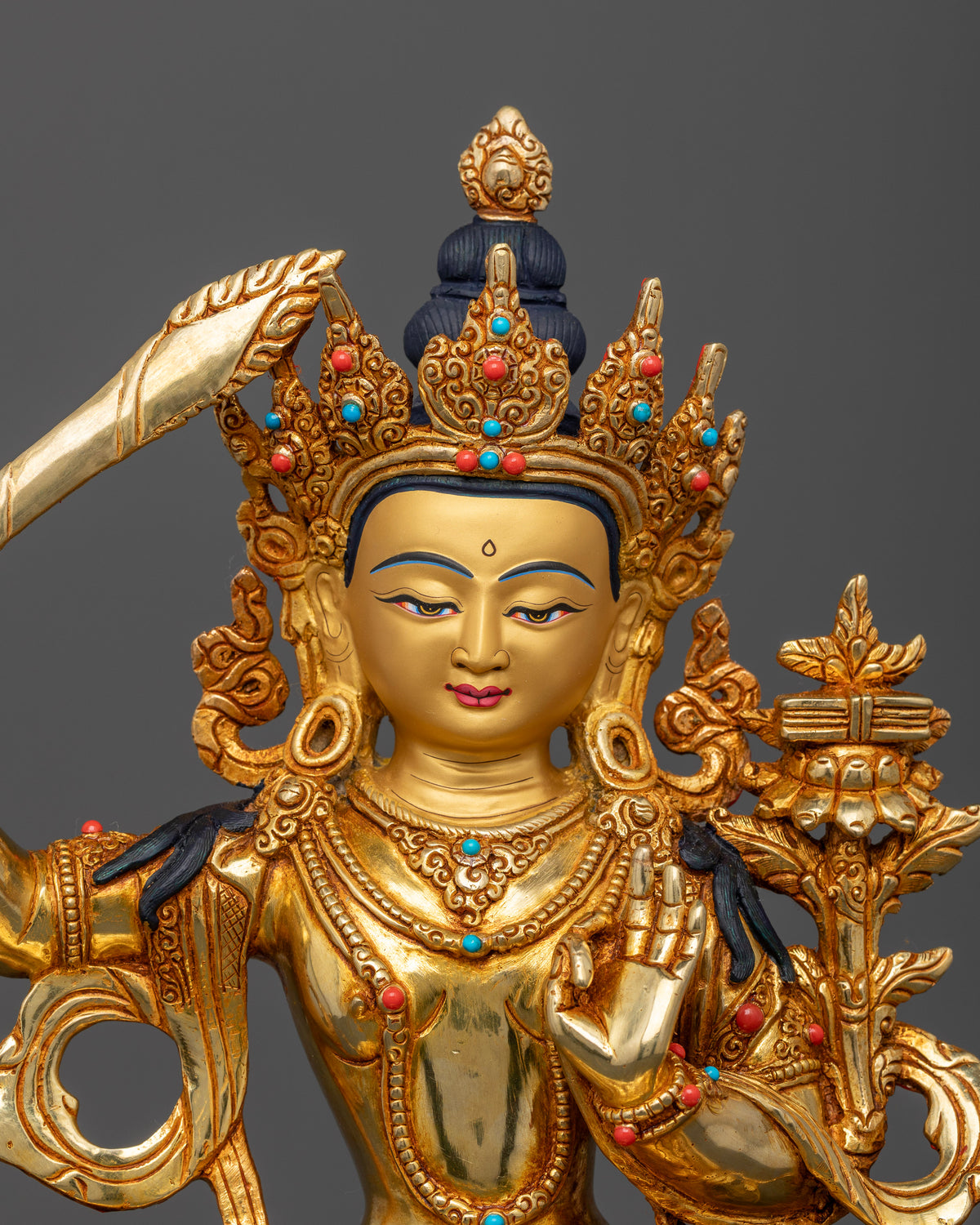 Manjushri statue close up 24K gold painted face semi precious stones layered necklaces Newari craftsmanship.