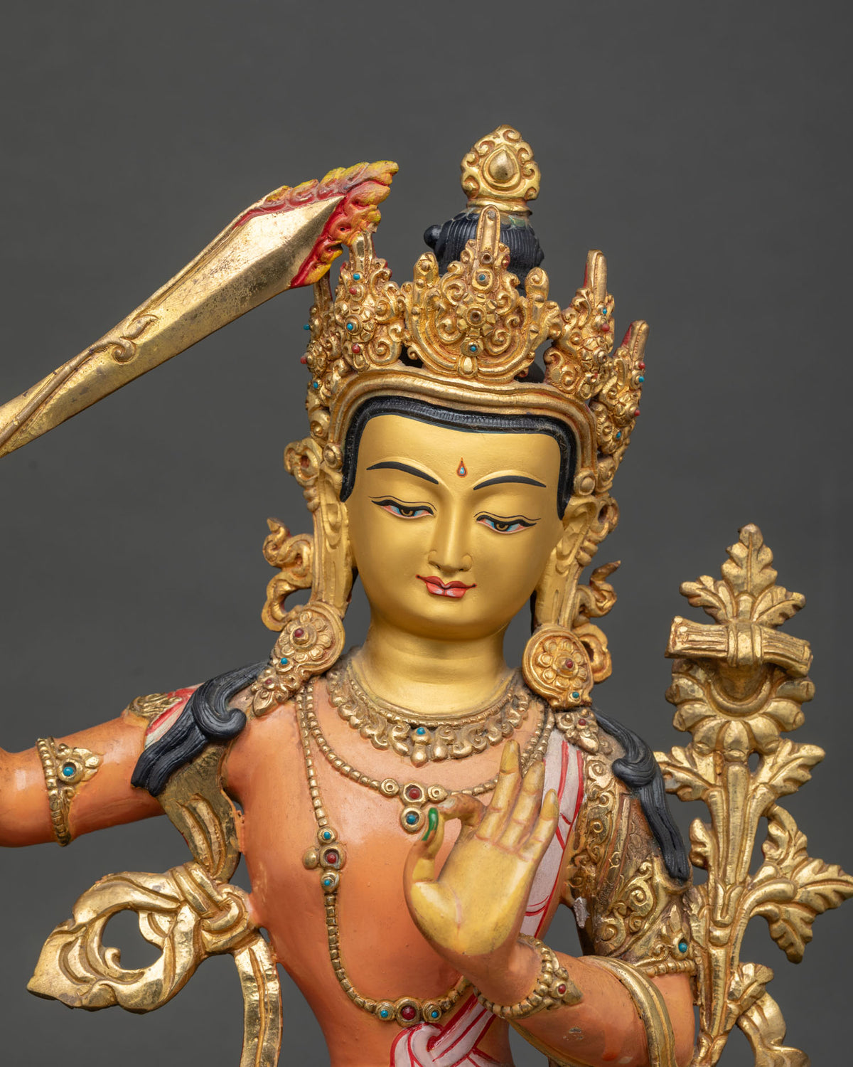 Manjushri statue copper Buddhist sculpture with 24K gold painted face and semi precious stones.