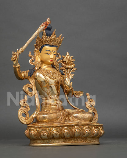 Manjushri Statue detail flaming wisdom sword Prajnaparamita Sutra double lotus pedestal.