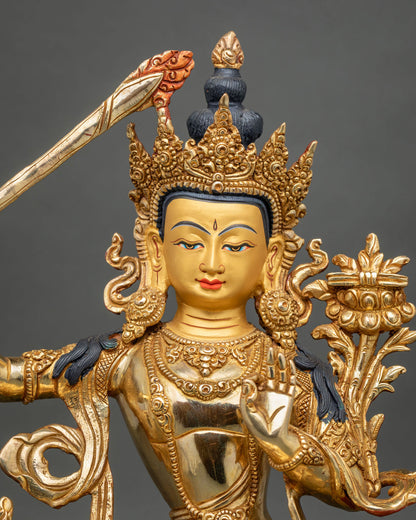 Manjushri Statue face close up 24K gold painted face ornate five jewel crown.