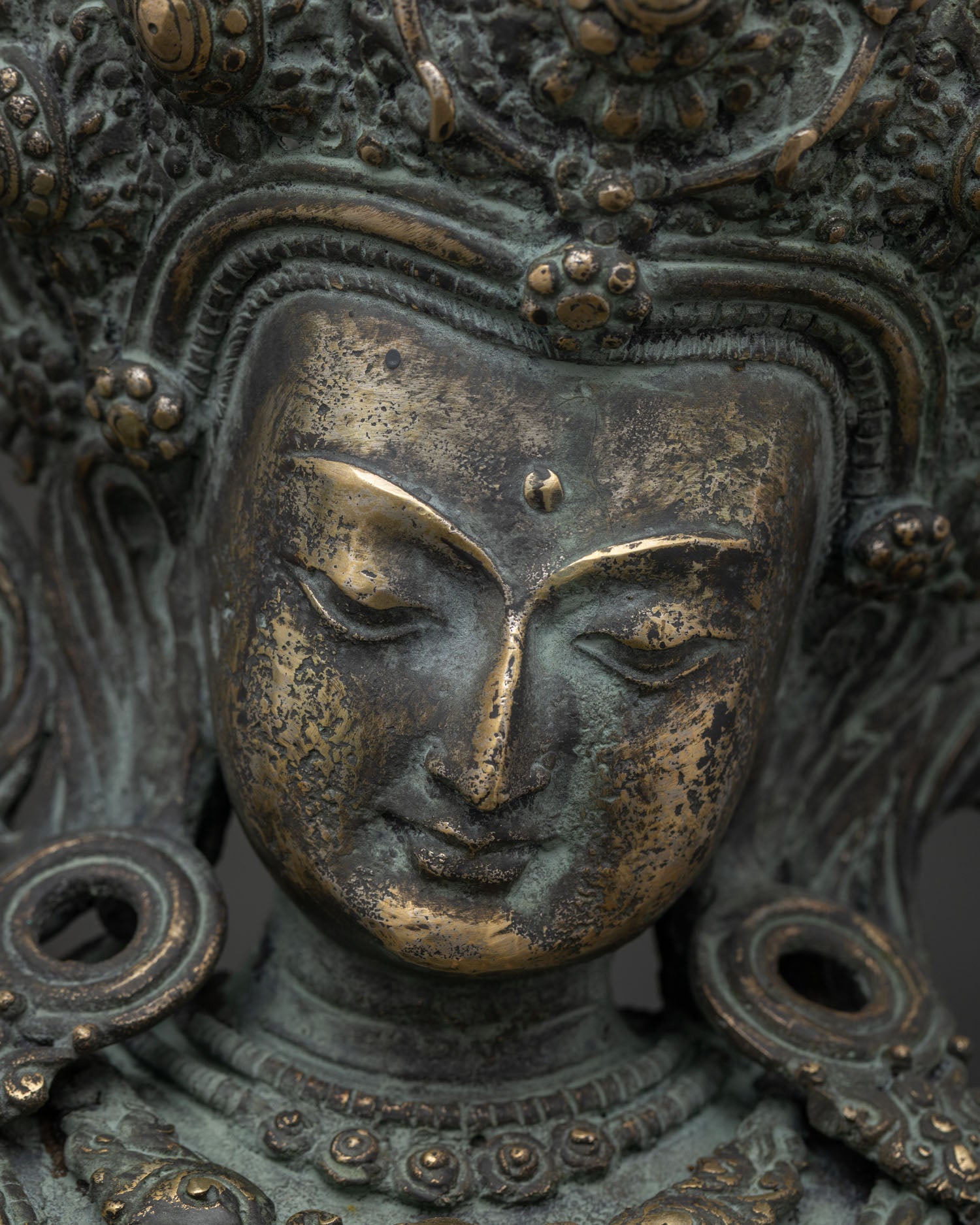 Manjushri Statue face Chiang Mai, serene bronze bodhisattva expression detail