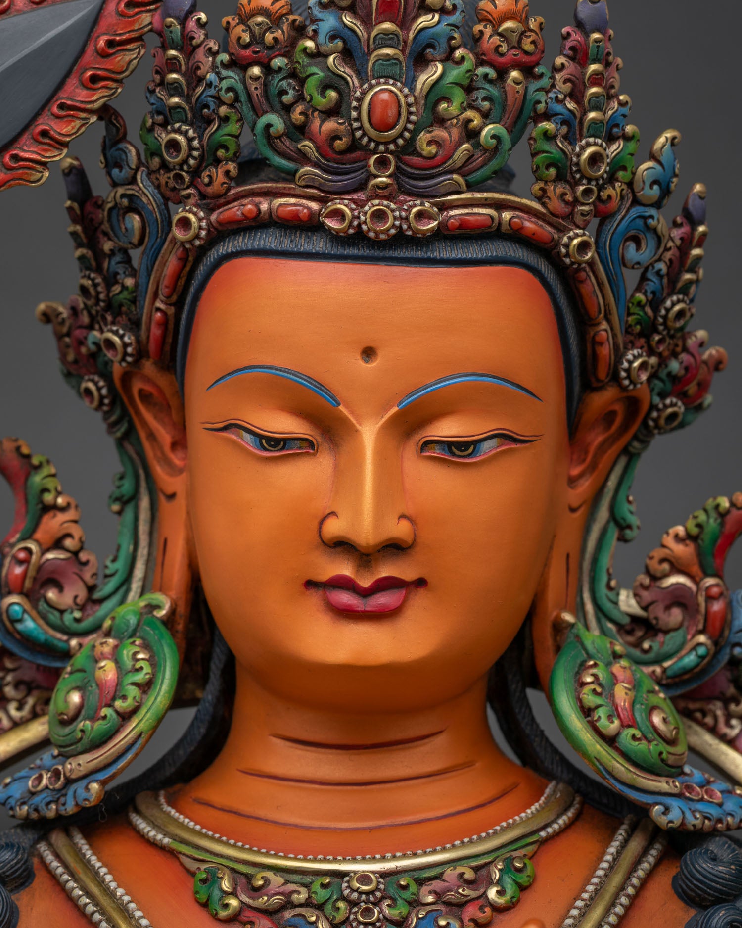 Manjushri statue face close up serene expression gold painted features Newari artisan Nepal