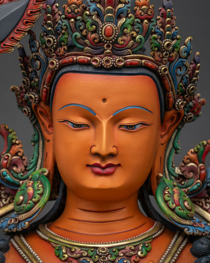 Manjushri statue face close up serene expression gold painted features Newari artisan Nepal