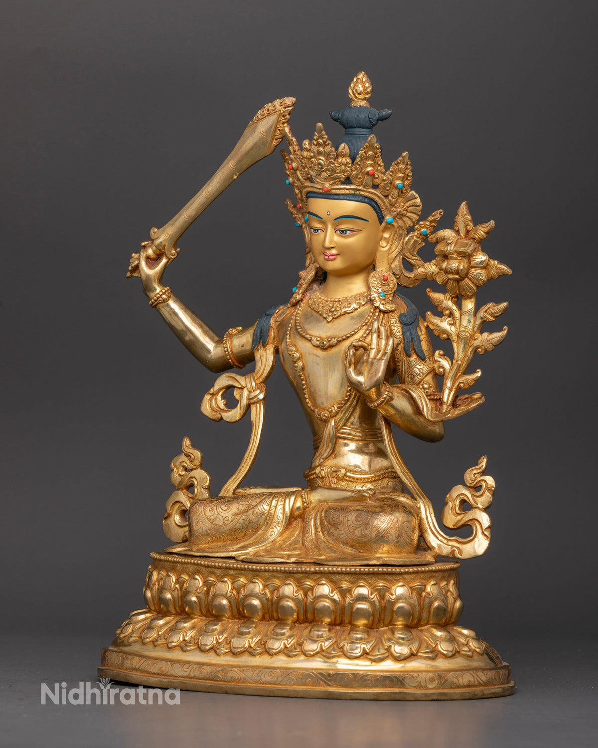 Manjushri statue five jewel crown floral garment gold gilded side view.
