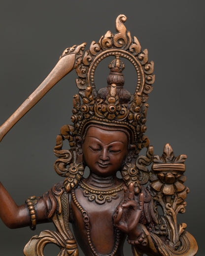 Manjushri Statue holding the flaming sword of wisdom and lotus.